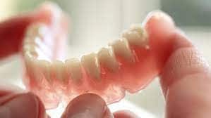 SMART Blog 10 A removable denture held in a hand