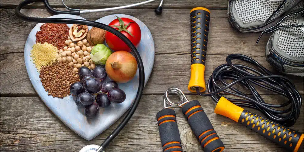 How fitness can protect an aging brain. 1 Healthy food arranged in a heart-shaped dish with exercise equipment